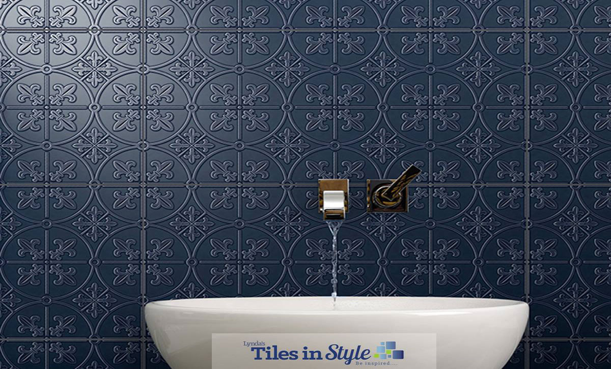 Navy blue pressed wall tiles behind a sink
